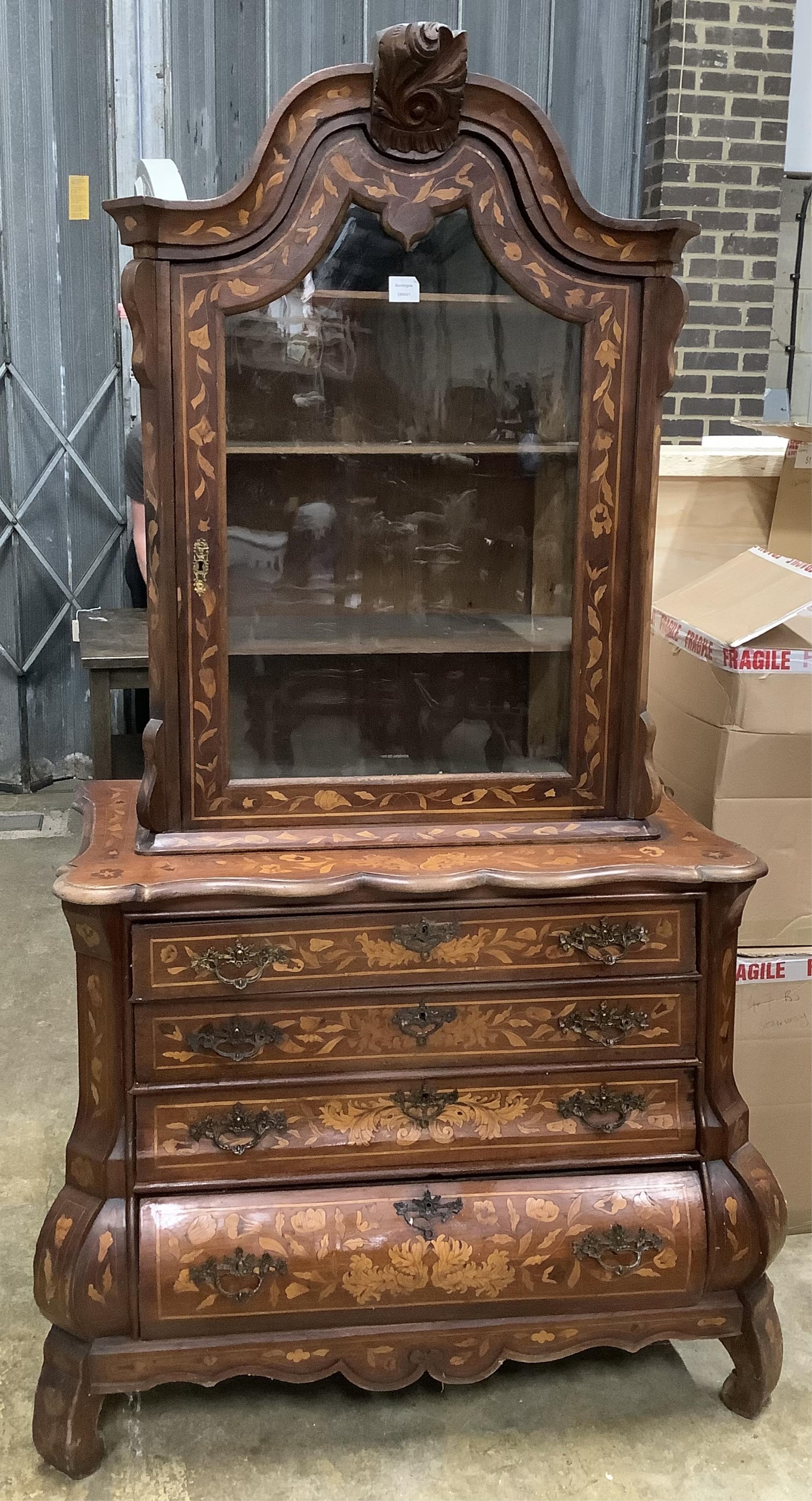 An early 19th century Dutch walnut and marquetry bombe cabinet on chest, width 109cm, height 190cm. Condition - little faded in places, fair to good